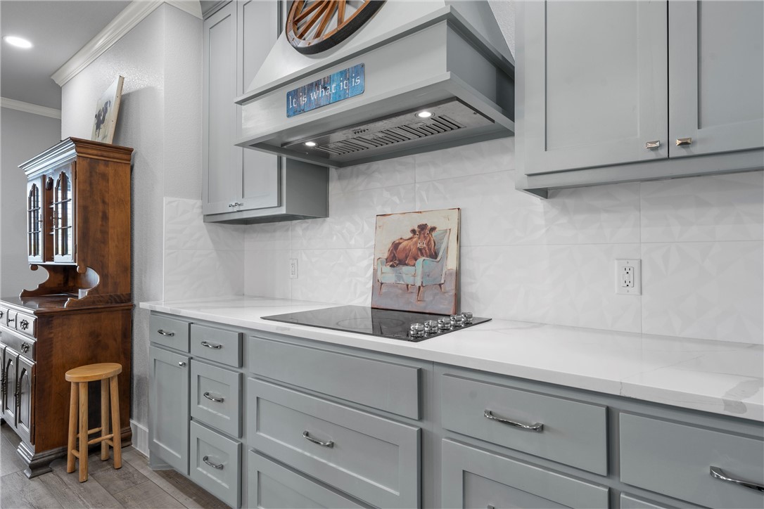 1227 Alexander Road Moody, TX 76557 - Photo 15 of 66 a kitchen with cabinets and a wooden floor