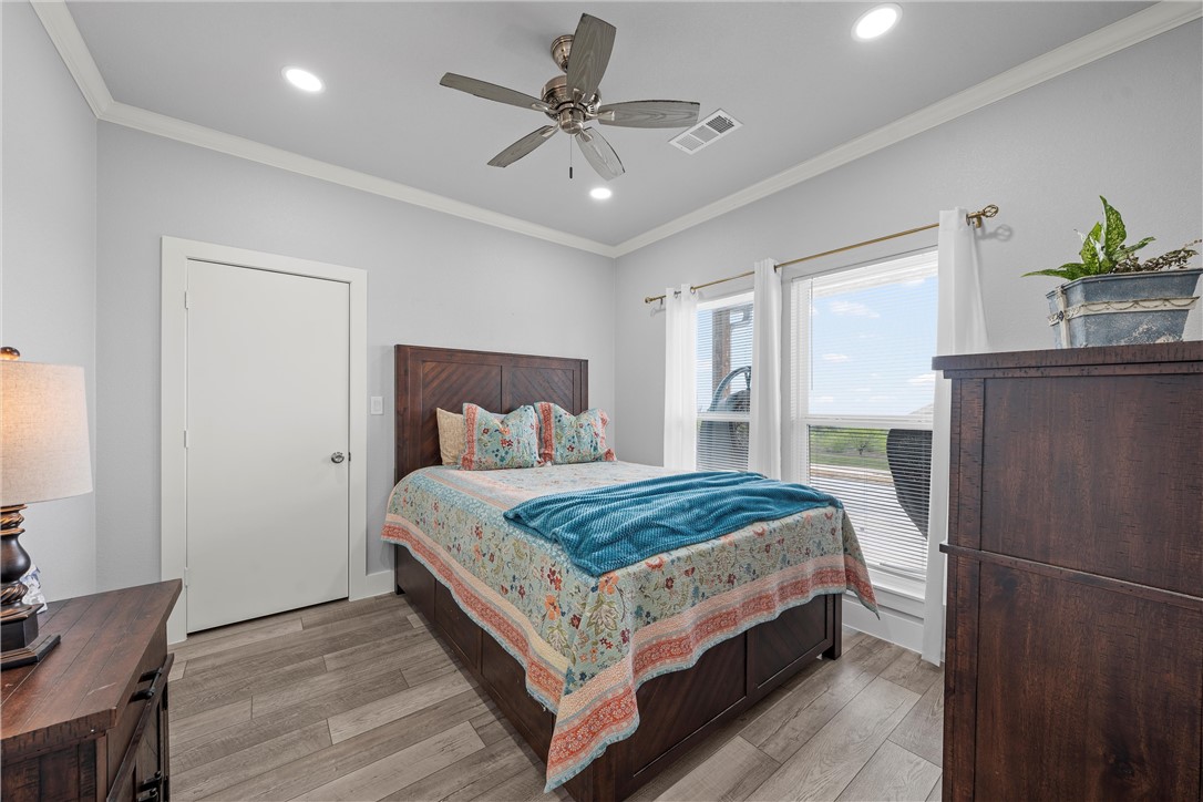 1227 Alexander Road Moody, TX 76557 - Photo 22 of 66 a bedroom with a bed and a chandelier