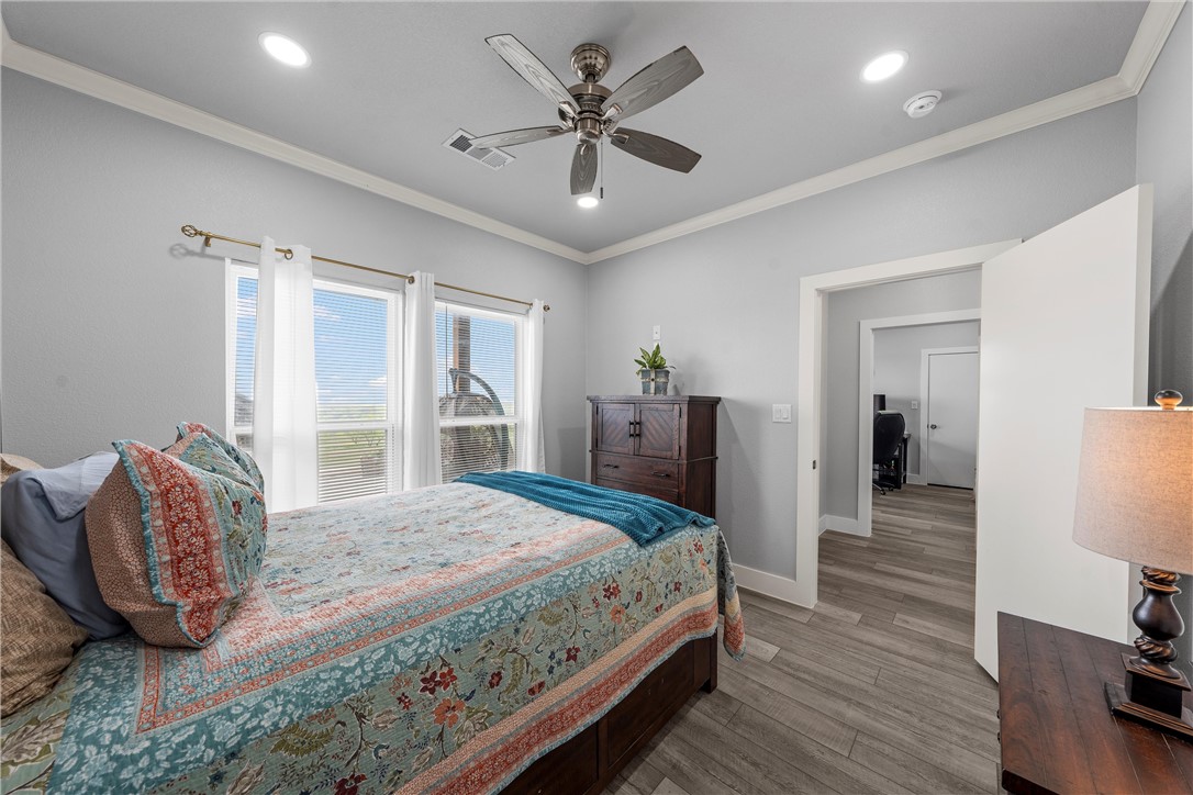 1227 Alexander Road Moody, TX 76557 - Photo 23 of 66 a bedroom with a large bed and a chandelier