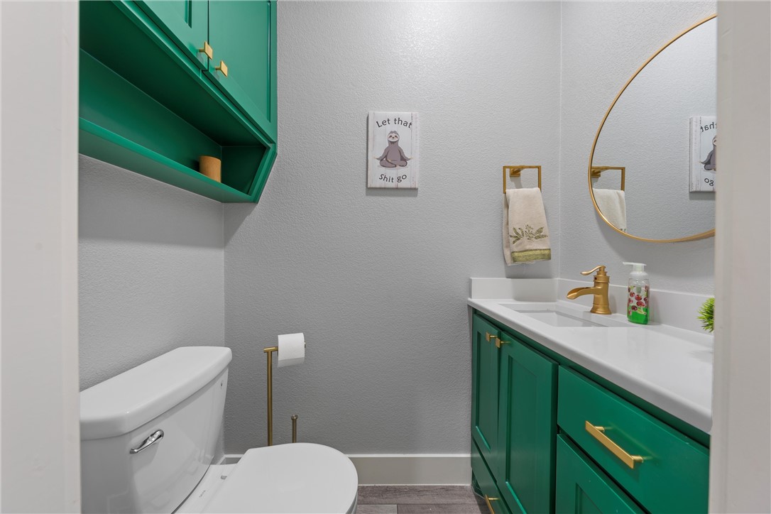 1227 Alexander Road Moody, TX 76557 - Photo 34 of 66 a bathroom with a toilet sink and mirror