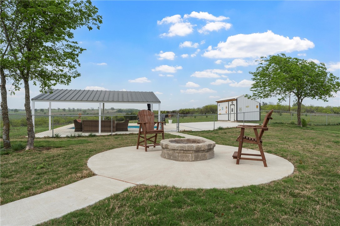 1227 Alexander Road Moody, TX 76557 - Photo 47 of 66 a view of a backyard with table and chairs under an umbrella