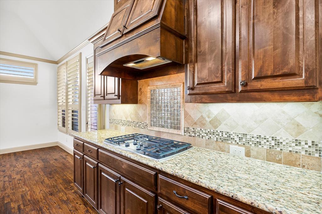 6814 Springwood Lane Garland, TX 75044 - Photo 18 of 33 a kitchen with stainless steel appliances granite countertop a stove a sink and a microwave