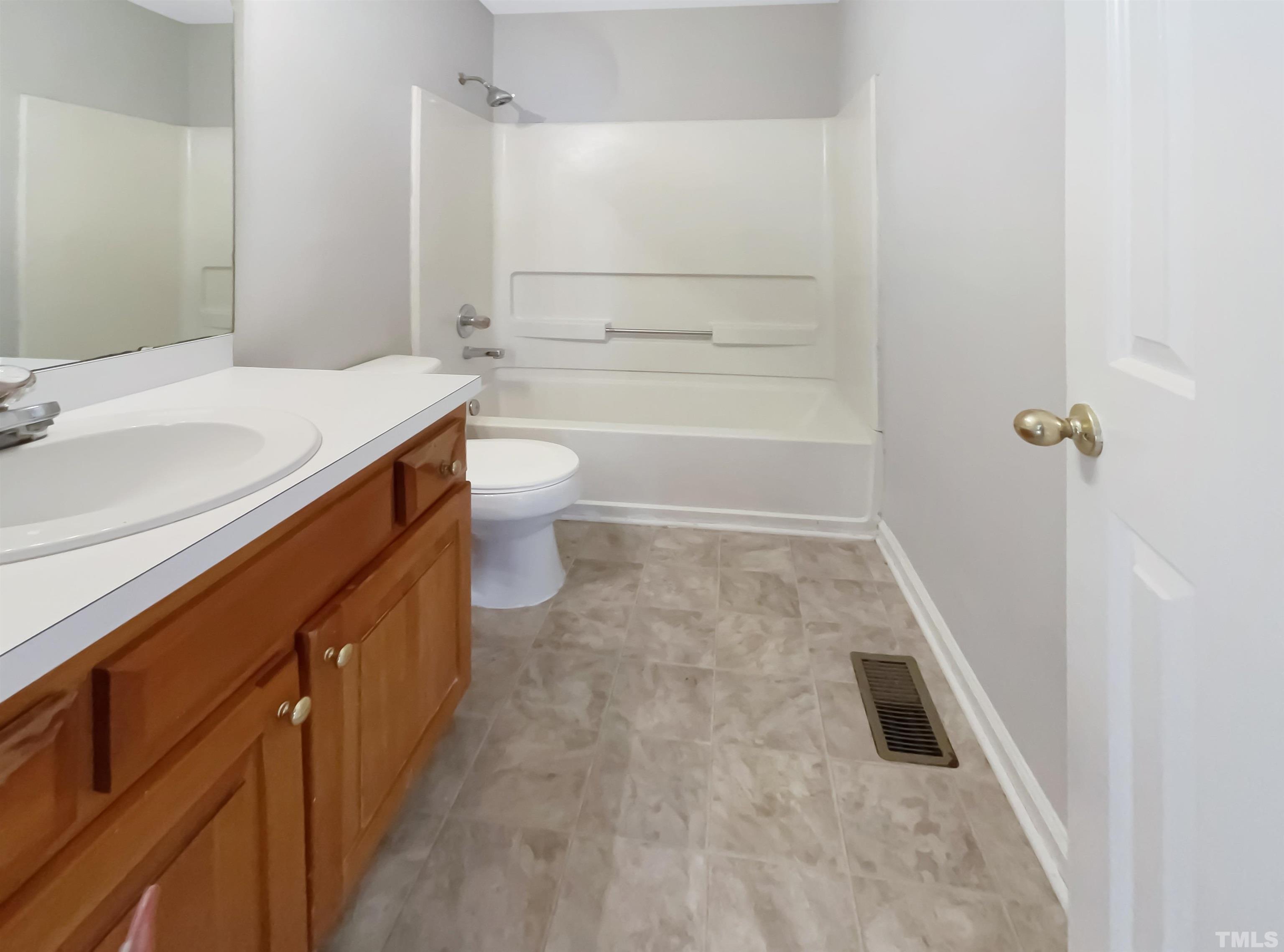 1105 Curtiss Drive Garner, NC 27529 - Photo 6 of 17 a bathroom with a sink a toilet and shower
