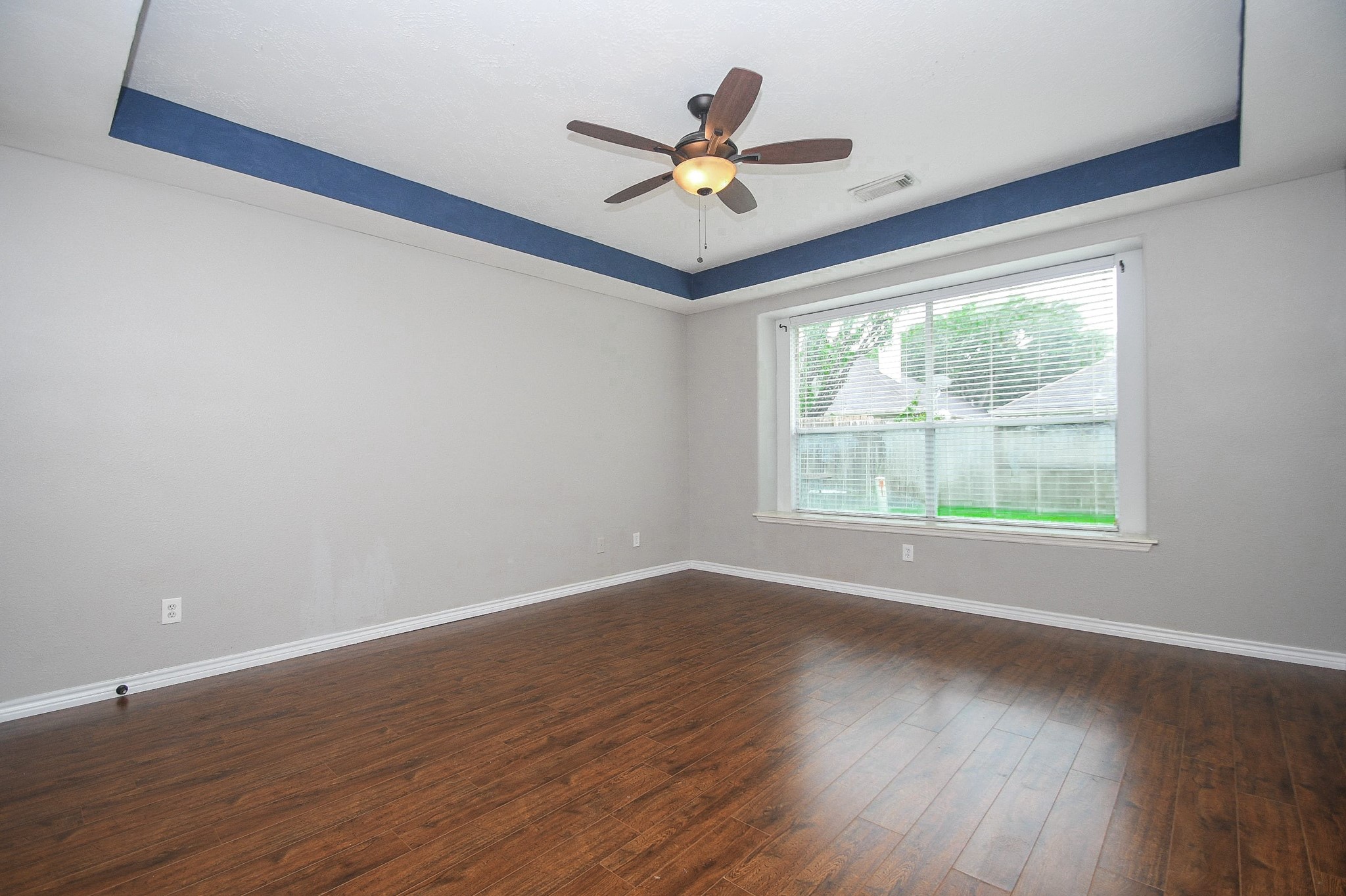 5602 Walkabout Way Katy, TX 77450 - Photo 17 of 33 a view of an empty room with wooden floor and a window
