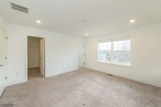 a view of an empty room with windows