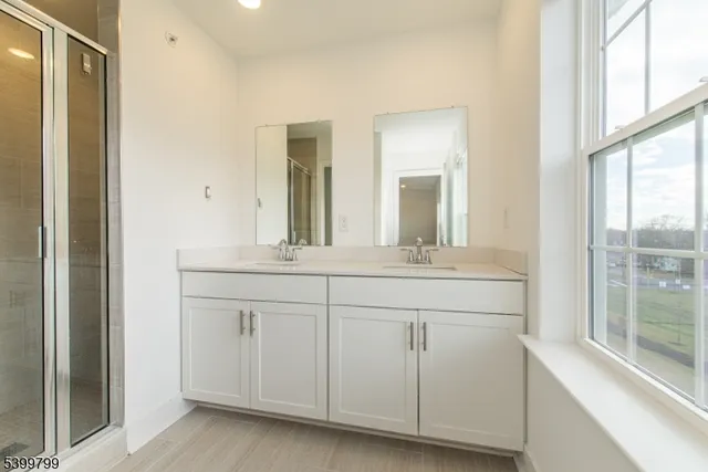 a bathroom with a double vanity sink and mirror