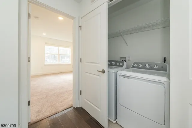 a view of storage and utility room with washer and dryer