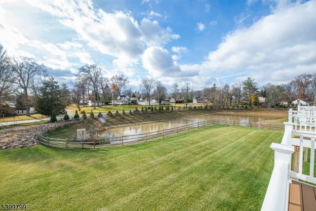 a view of a lake with houses in the background