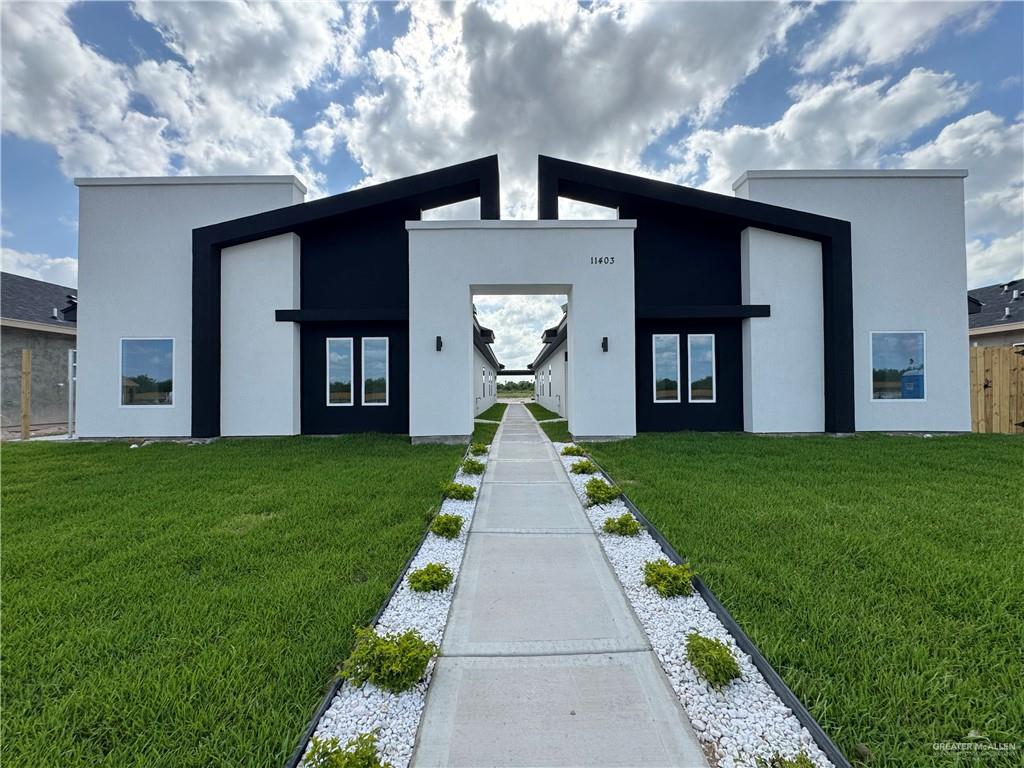 a front view of a house with garden