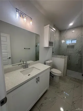 a bathroom with a sink toilet and mirror