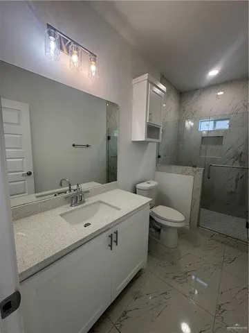 a bathroom with a sink toilet and mirror