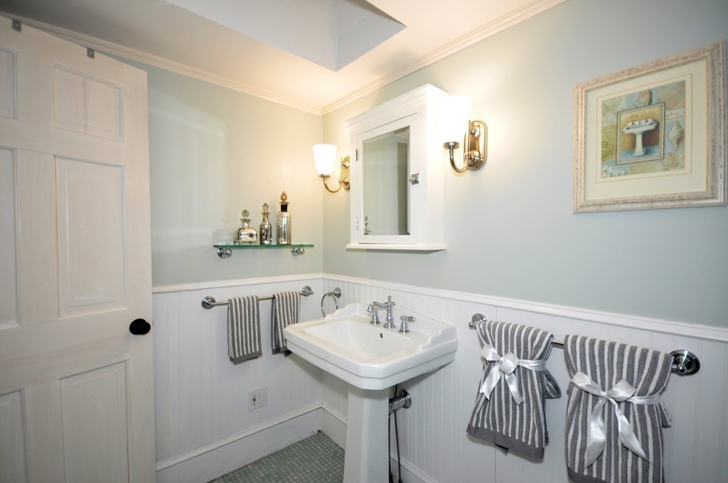 29 Lincoln Road Lincoln, MA 01773 - Photo 13 of 19 a bathroom with a sink a mirror and a window