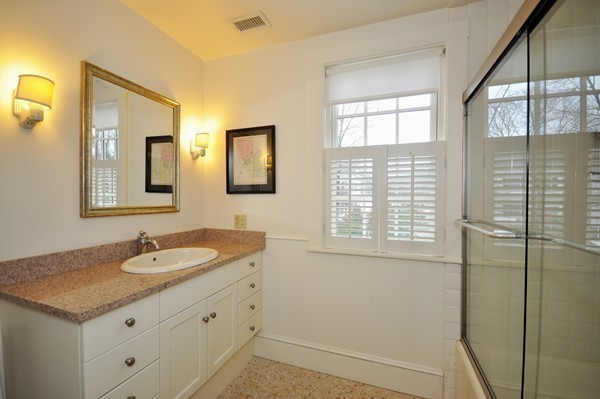 29 Lincoln Road Lincoln, MA 01773 - Photo 15 of 19 a bathroom with a granite countertop sink and a mirror