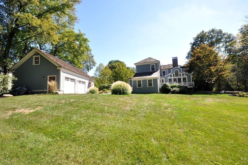 29 Lincoln Road Lincoln, MA 01773 - Photo 3 of 19 a front view of a house with a yard and garage