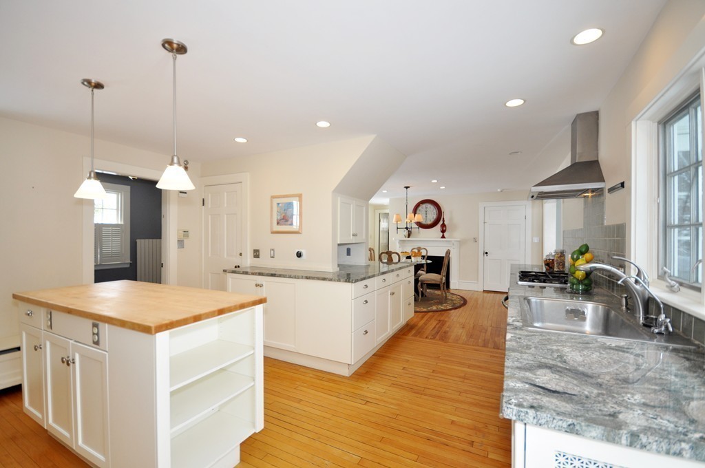29 Lincoln Road Lincoln, MA 01773 - Photo 6 of 19 a large kitchen with kitchen island a stove a sink a center island and couches