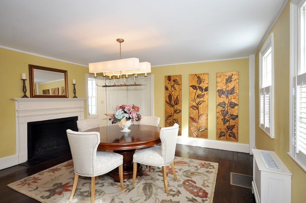29 Lincoln Road Lincoln, MA 01773 - Photo 10 of 19 a dining room with furniture a fireplace and wooden floor