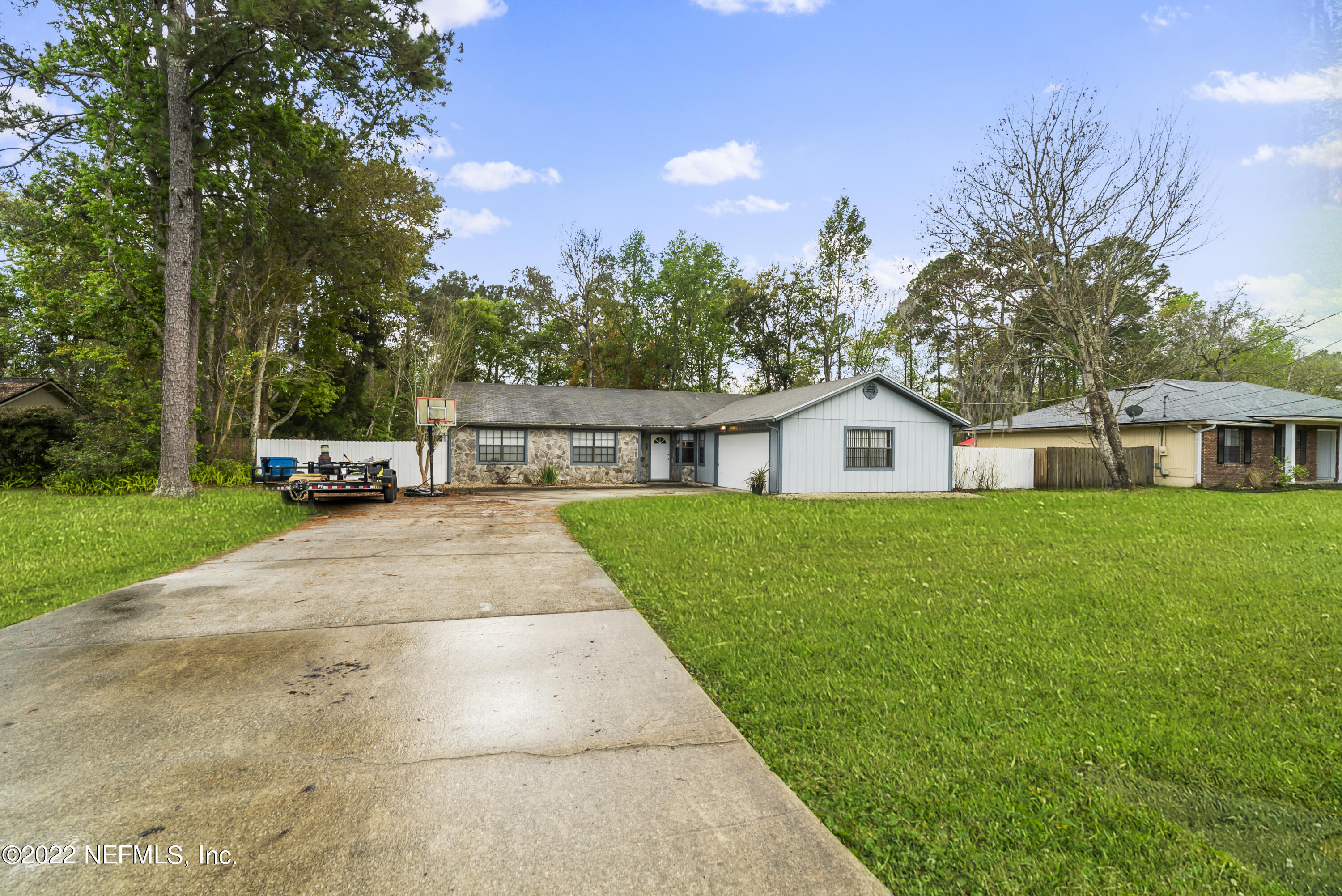 288 West Shores Road Fleming Island, FL 32003 - Photo 1 of 36 a front view of a house with a yard and trees