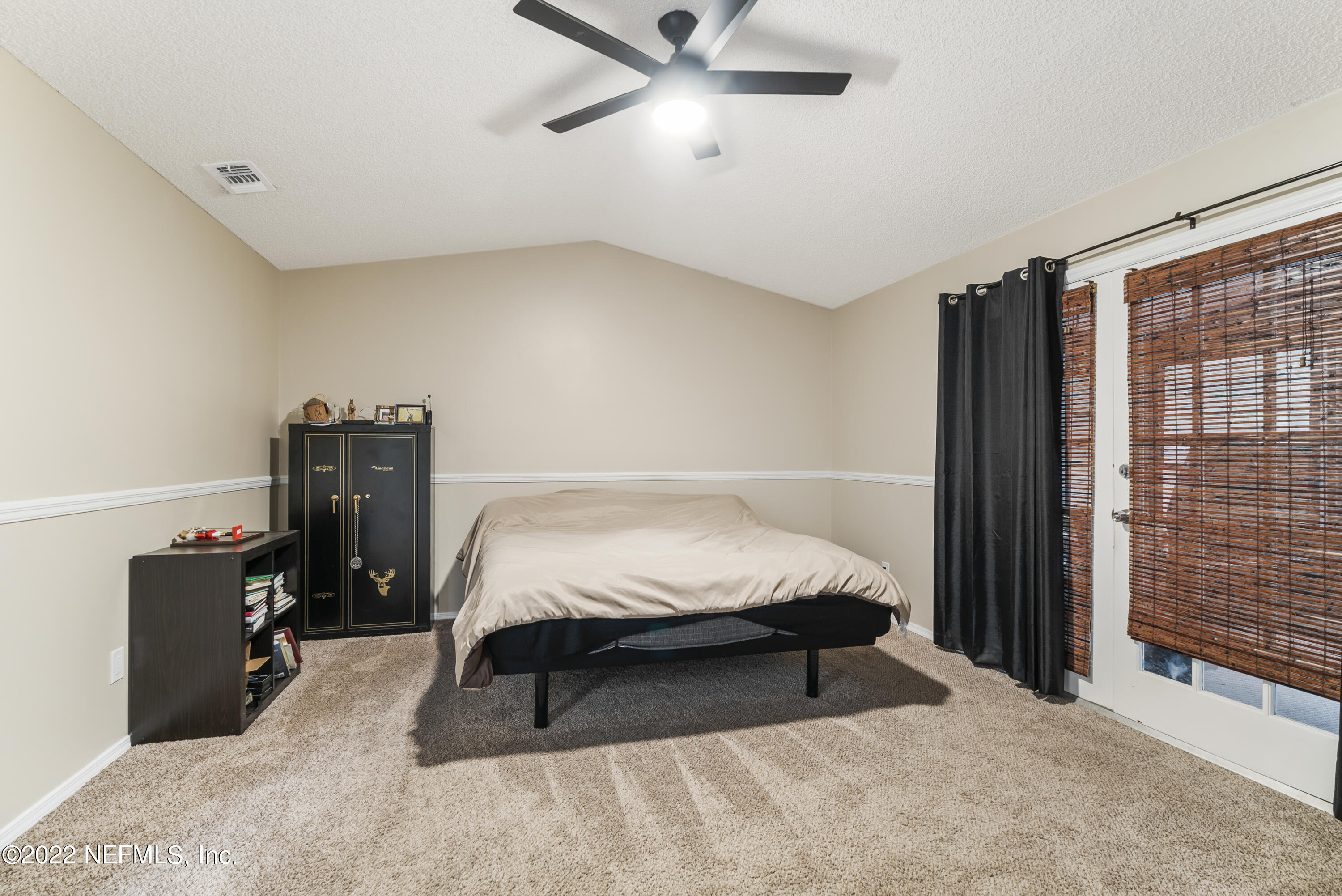 288 West Shores Road Fleming Island, FL 32003 - Photo 11 of 36 a bedroom with a bed and cabinets
