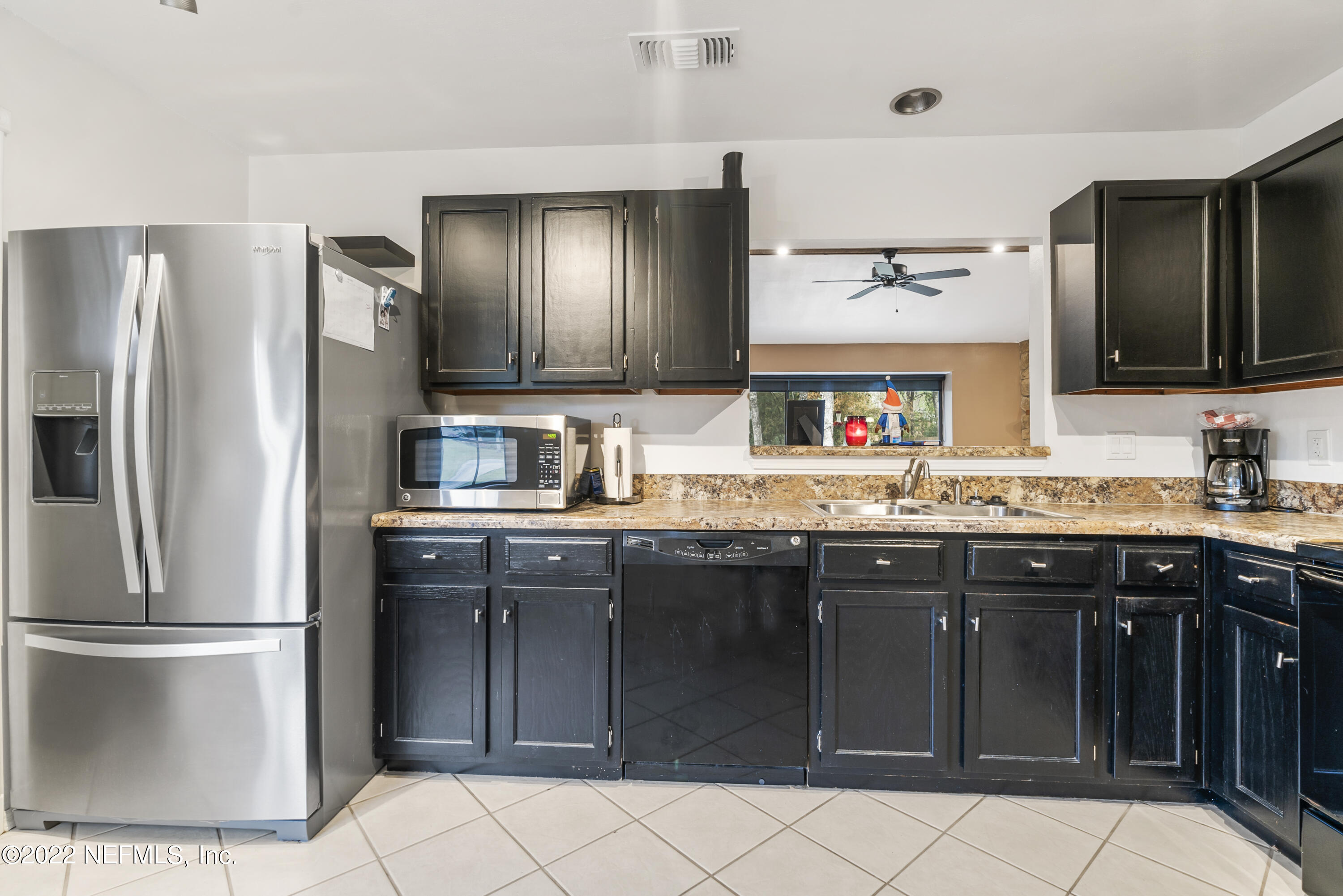288 West Shores Road Fleming Island, FL 32003 - Photo 19 of 36 a kitchen with stainless steel appliances granite countertop a refrigerator and a sink