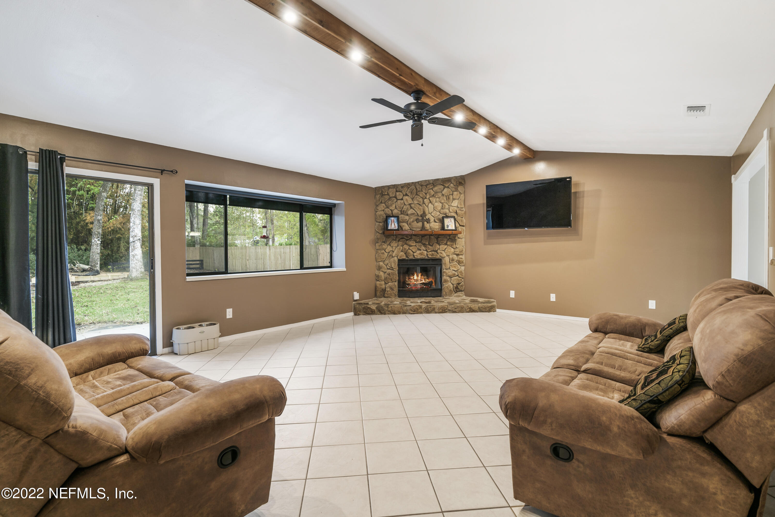 288 West Shores Road Fleming Island, FL 32003 - Photo 22 of 36 a living room with furniture and a flat screen tv