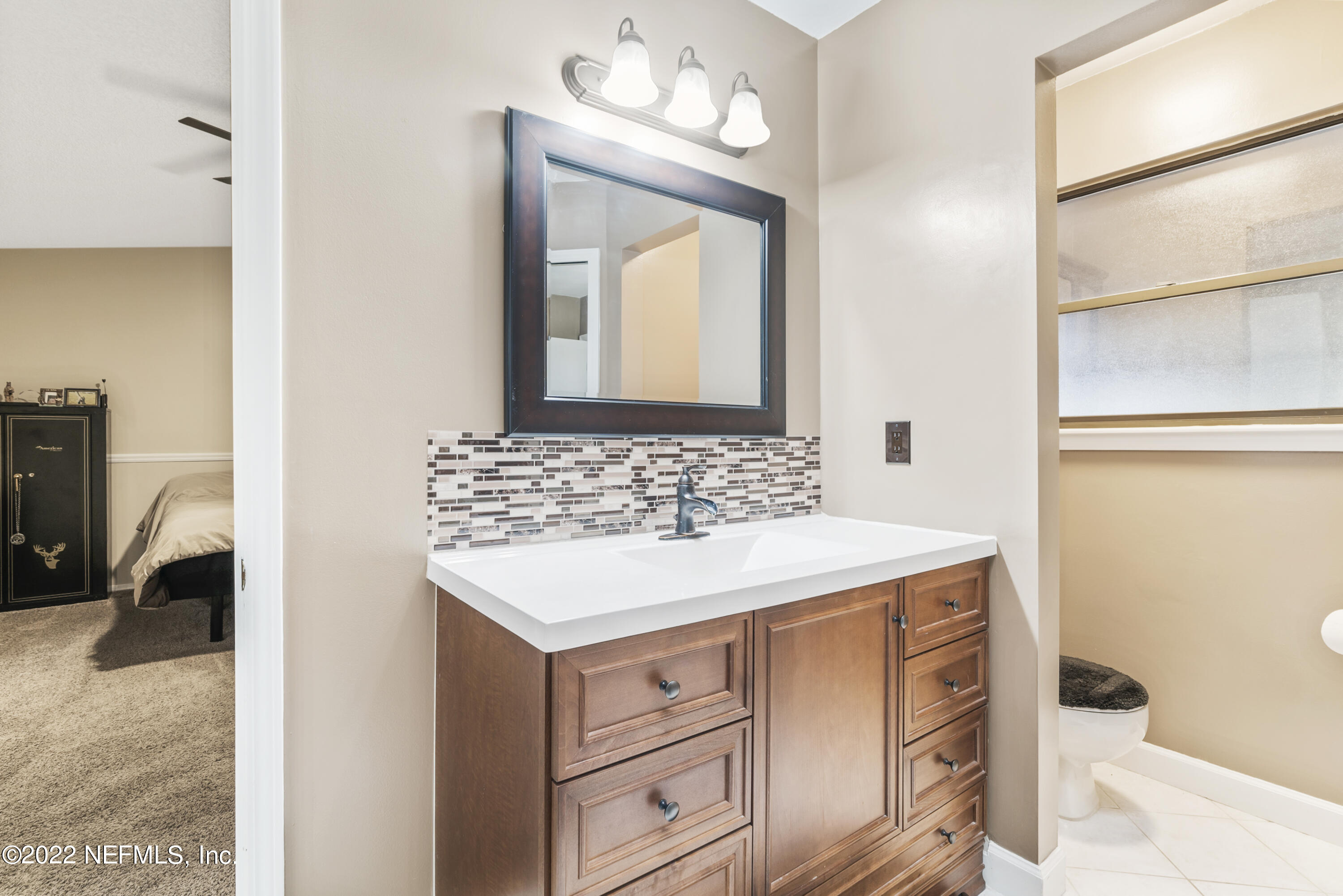 288 West Shores Road Fleming Island, FL 32003 - Photo 6 of 36 a bathroom with a sink and a mirror