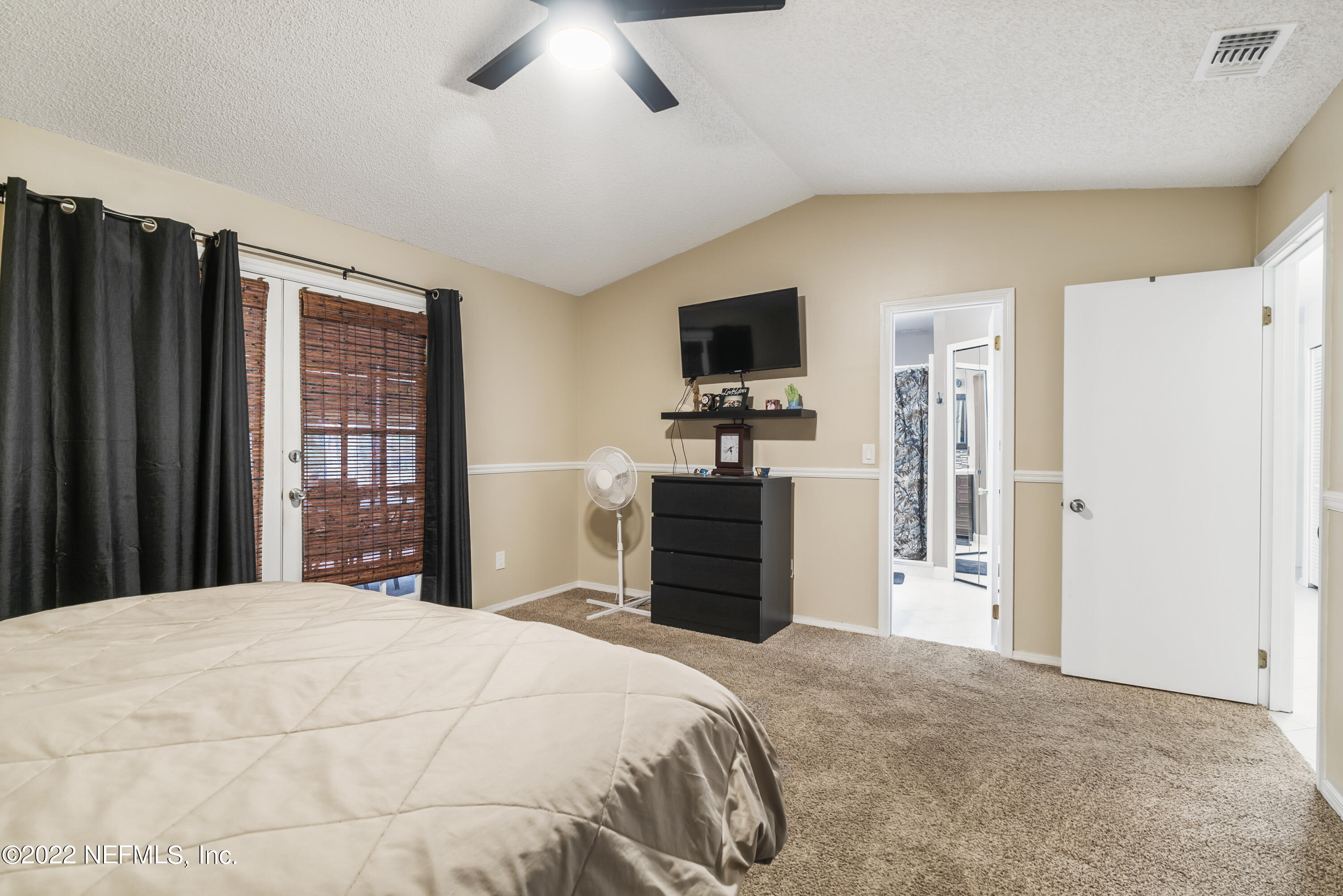 288 West Shores Road Fleming Island, FL 32003 - Photo 7 of 36 a bedroom with a bed and a flat screen tv