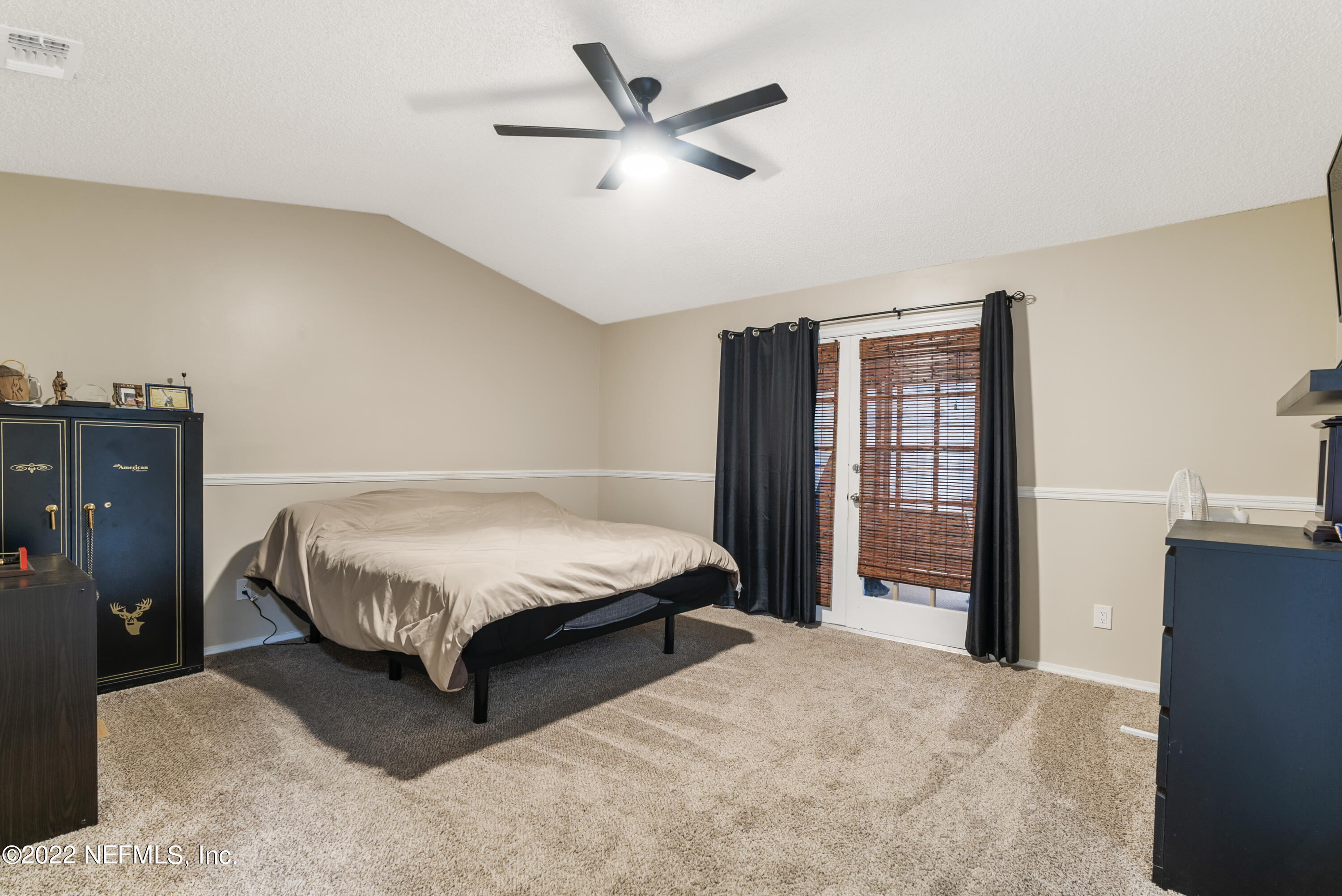 288 West Shores Road Fleming Island, FL 32003 - Photo 8 of 36 a bedroom with a bed dresser and a large window