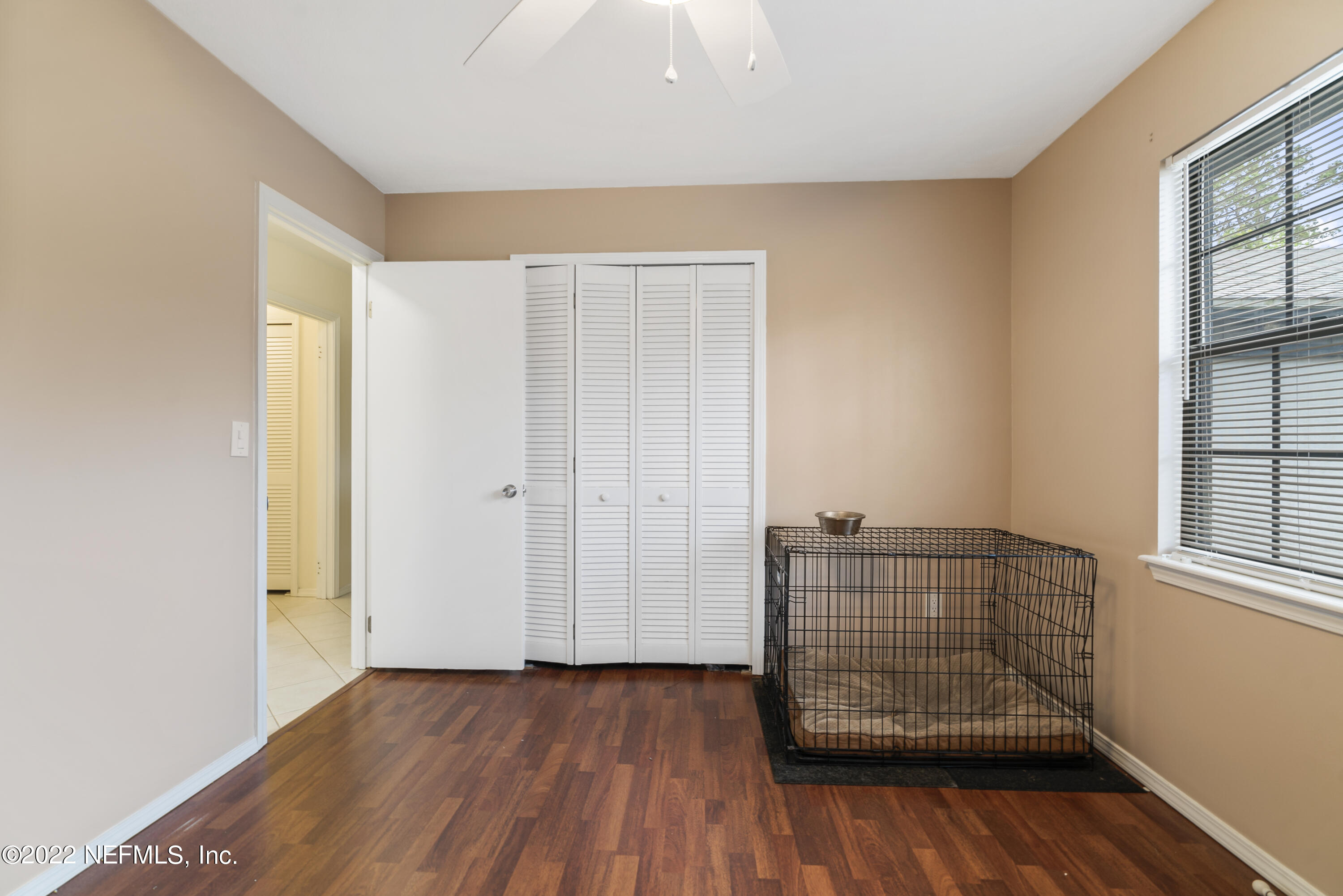 288 West Shores Road Fleming Island, FL 32003 - Photo 9 of 36 an empty room with wooden floor and windows
