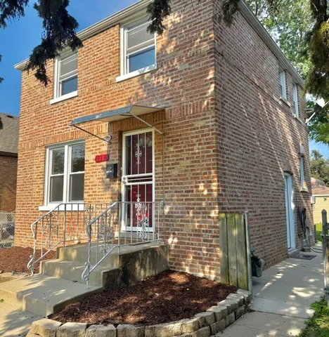 a brick building with a small yard