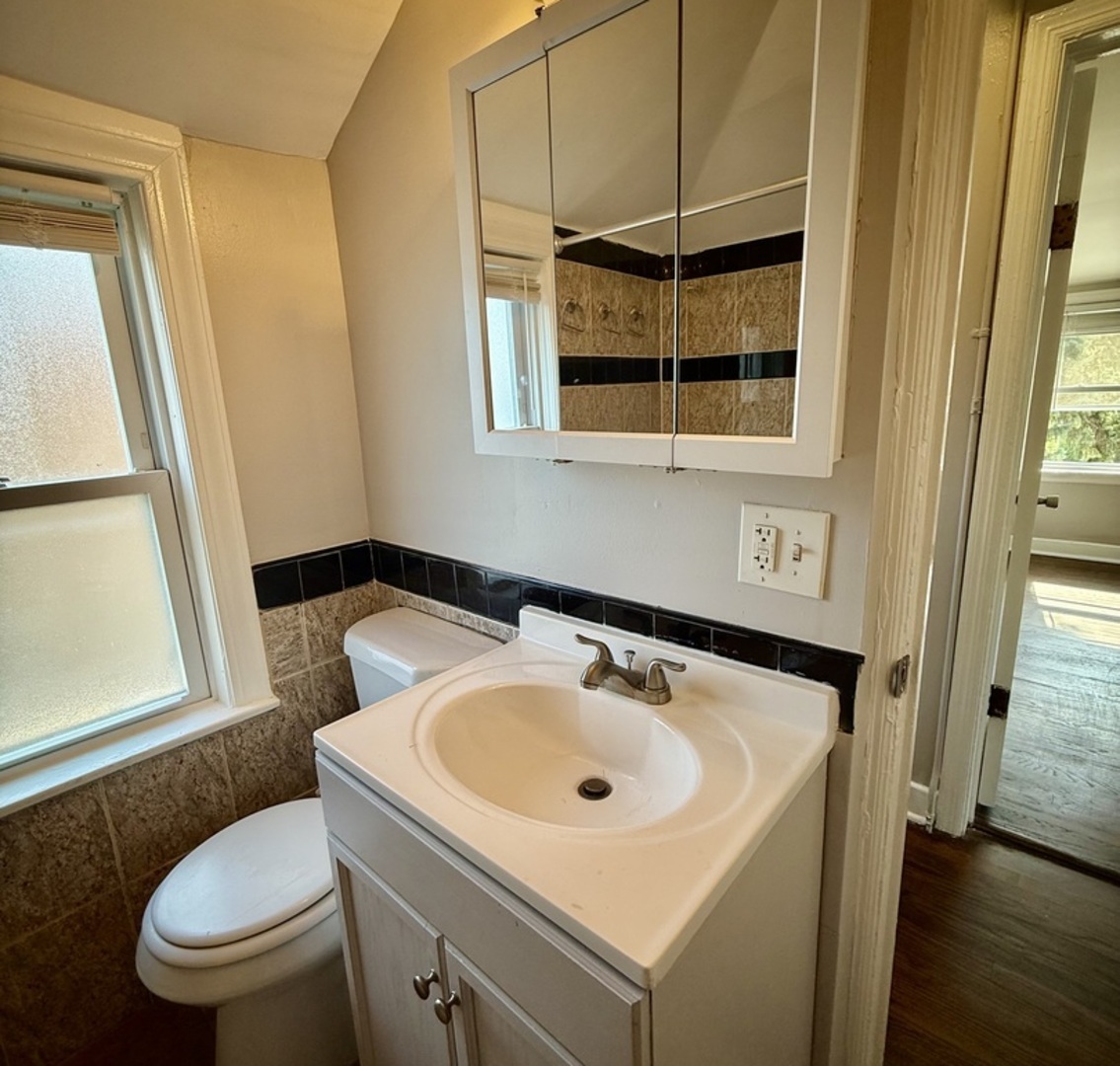 2003 South 24th Avenue Broadview, IL 60155 - Photo 7 of 14 a bathroom with a sink a toilet and a mirror