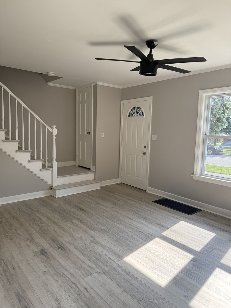 2003 South 24th Avenue Broadview, IL 60155 - Photo 9 of 14 a view of an empty room with a window and wooden floor