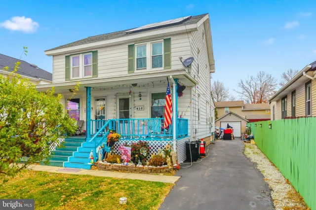 a view of street with a small yard and potted plants