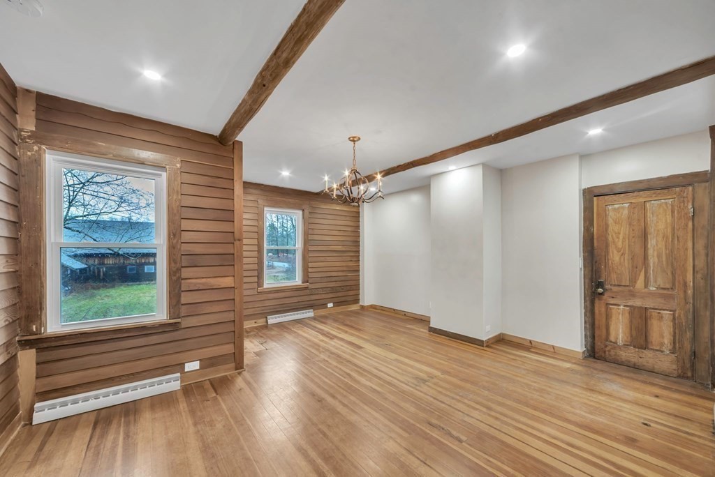 1385 Lyon Street Ludlow, MA 01056 - Photo 12 of 35 an empty room with wooden floor and windows