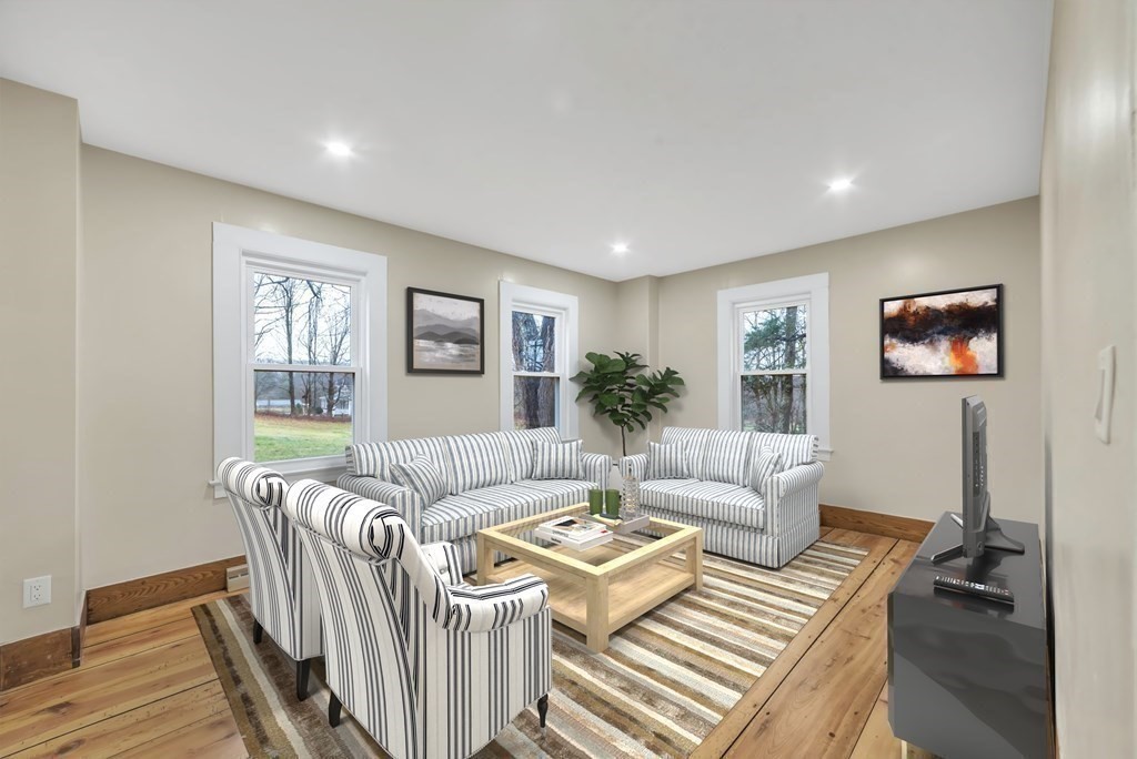 1385 Lyon Street Ludlow, MA 01056 - Photo 14 of 35 a living room with furniture and a wooden floor