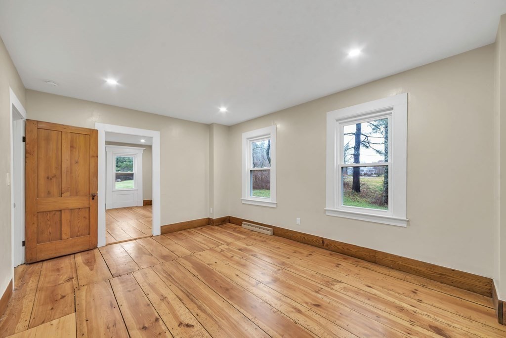 1385 Lyon Street Ludlow, MA 01056 - Photo 18 of 35 a view of an empty room with wooden floor and a window
