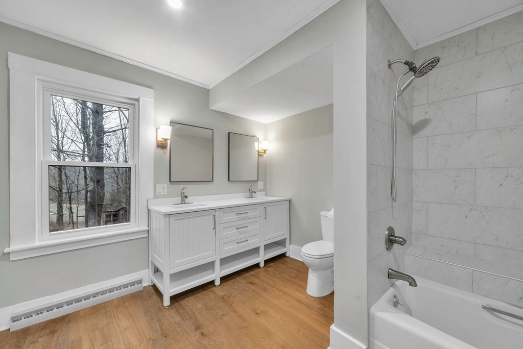 1385 Lyon Street Ludlow, MA 01056 - Photo 20 of 35 a bathroom with a bathtub sink toilet and mirror