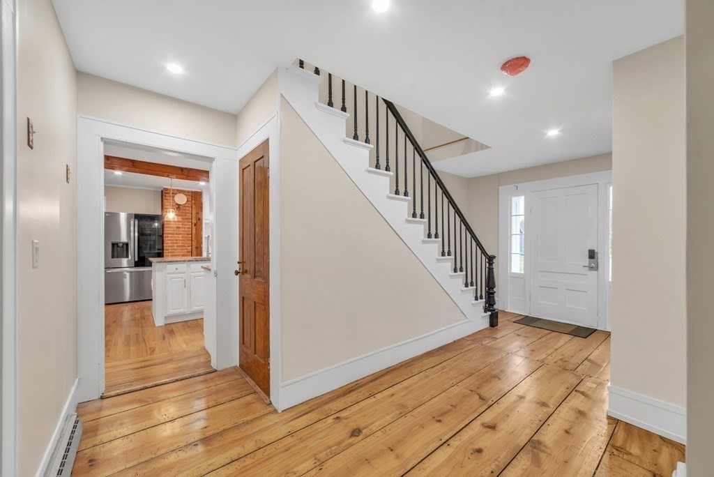 1385 Lyon Street Ludlow, MA 01056 - Photo 21 of 35 a view of a hallway with wooden floor and staircase