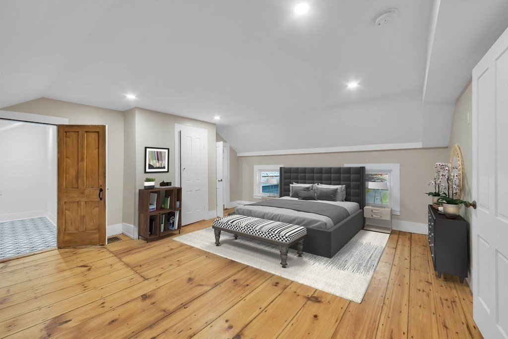 1385 Lyon Street Ludlow, MA 01056 - Photo 23 of 35 a spacious bedroom with a bed and wooden floor
