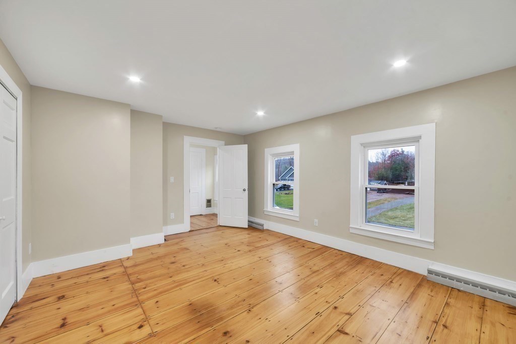 1385 Lyon Street Ludlow, MA 01056 - Photo 29 of 35 a view of an empty room with window and wooden floor