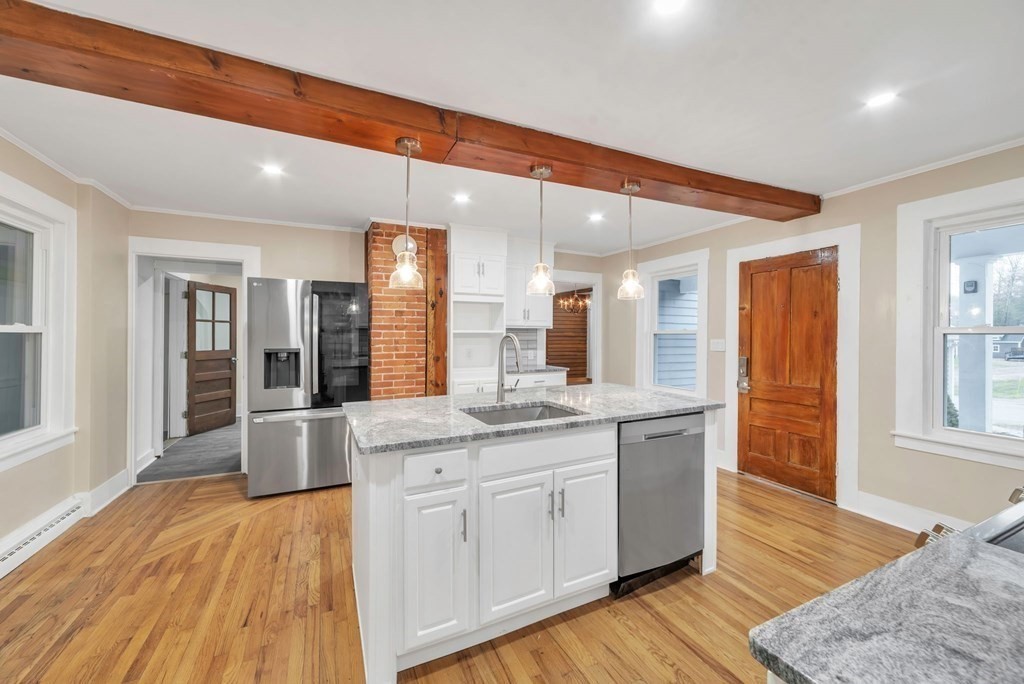 1385 Lyon Street Ludlow, MA 01056 - Photo 3 of 35 a large kitchen with granite countertop a large counter top space and stainless steel appliances