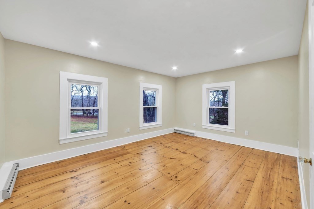 1385 Lyon Street Ludlow, MA 01056 - Photo 32 of 35 a view of an empty room with wooden floor and a window