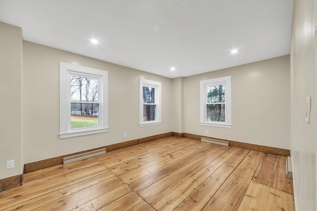 1385 Lyon Street Ludlow, MA 01056 - Photo 33 of 35 a view of an empty room with wooden floor and a window