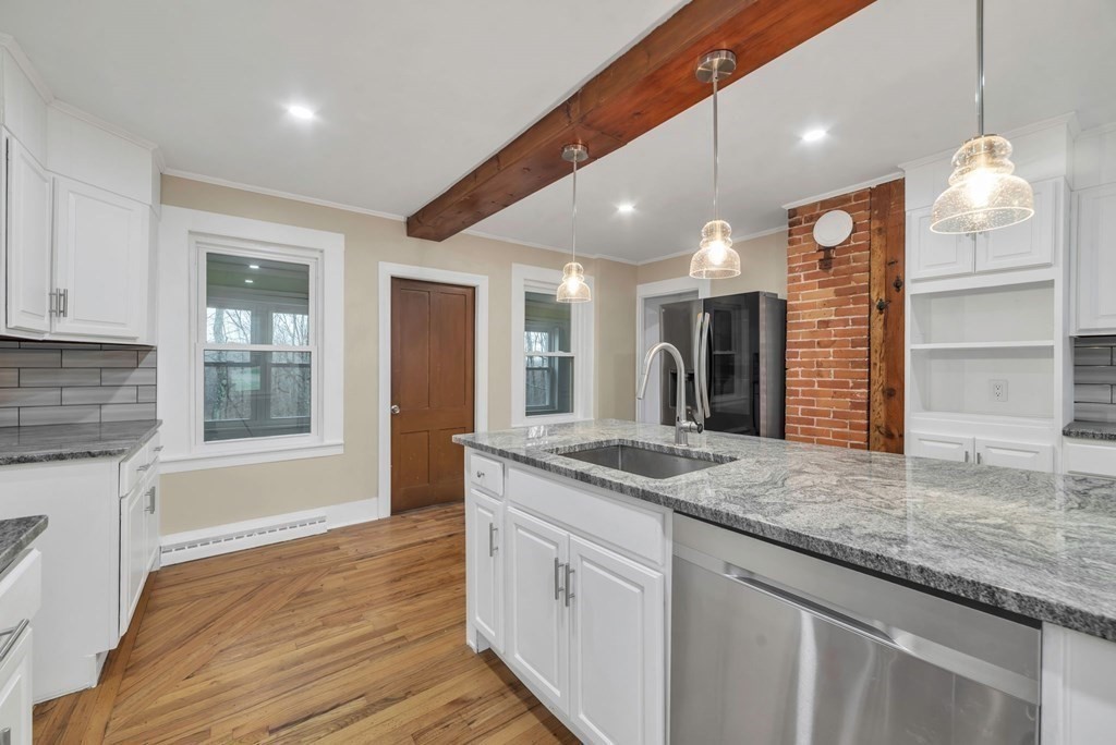 1385 Lyon Street Ludlow, MA 01056 - Photo 4 of 35 a kitchen with stainless steel appliances granite countertop a sink and a granite counter tops