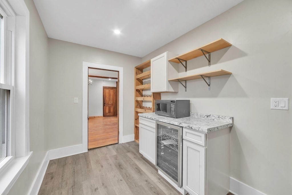 1385 Lyon Street Ludlow, MA 01056 - Photo 9 of 35 a kitchen with a wooden floor and a sink