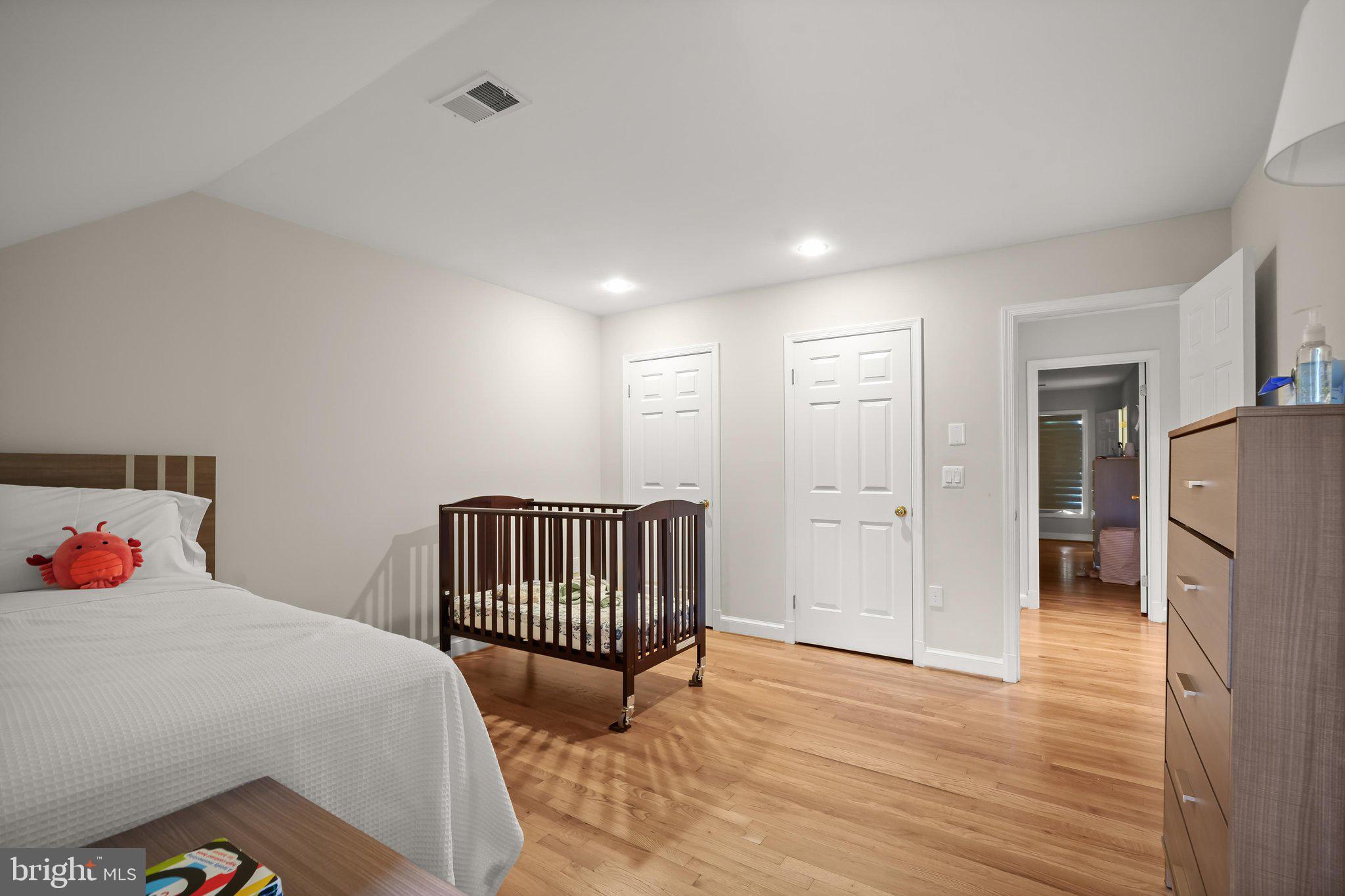 9809 Hall Road Potomac, MD 20854 - Photo 39 of 60 a bedroom with a bed and wooden floor