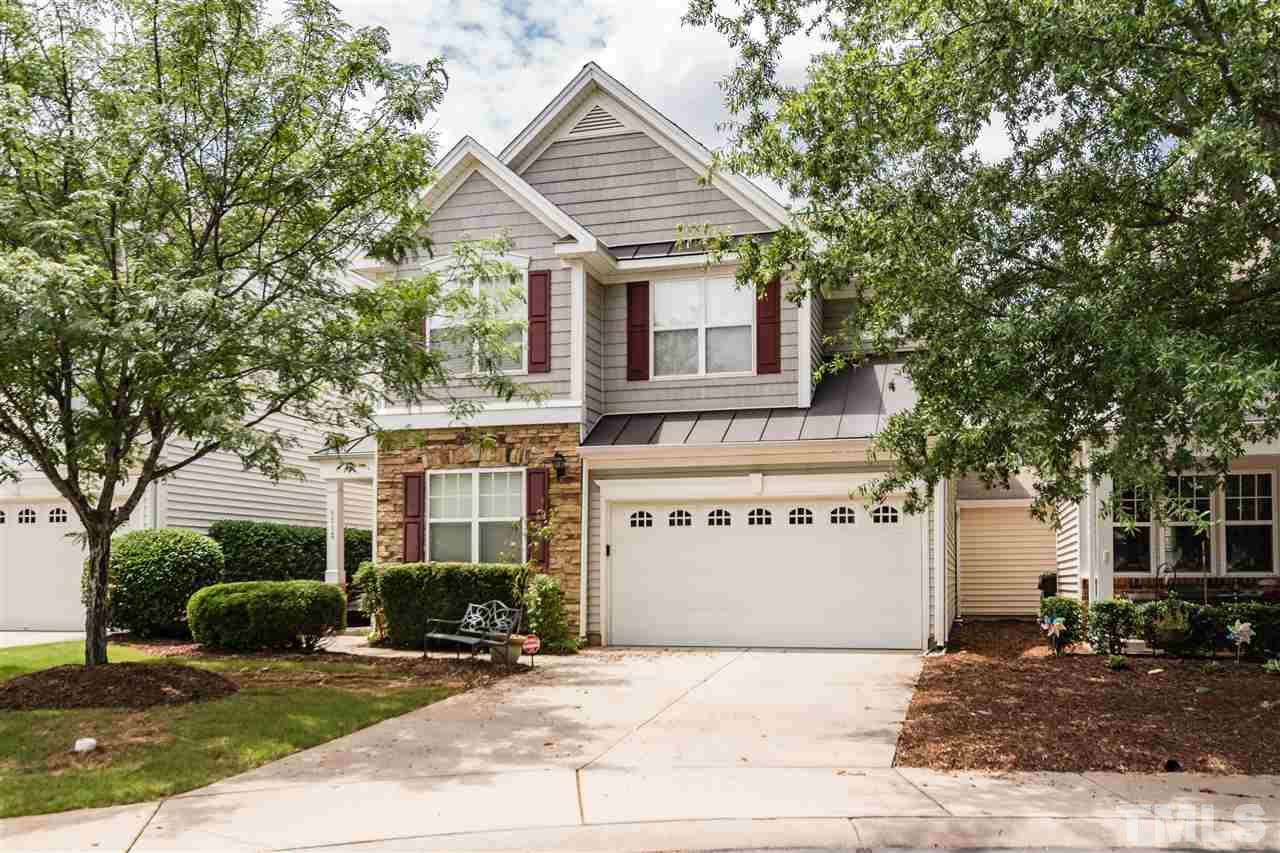 8313 Rubblestone Path Raleigh, NC 27613 - Photo 1 of 25 a view of a white house with a large windows and large tree and plants