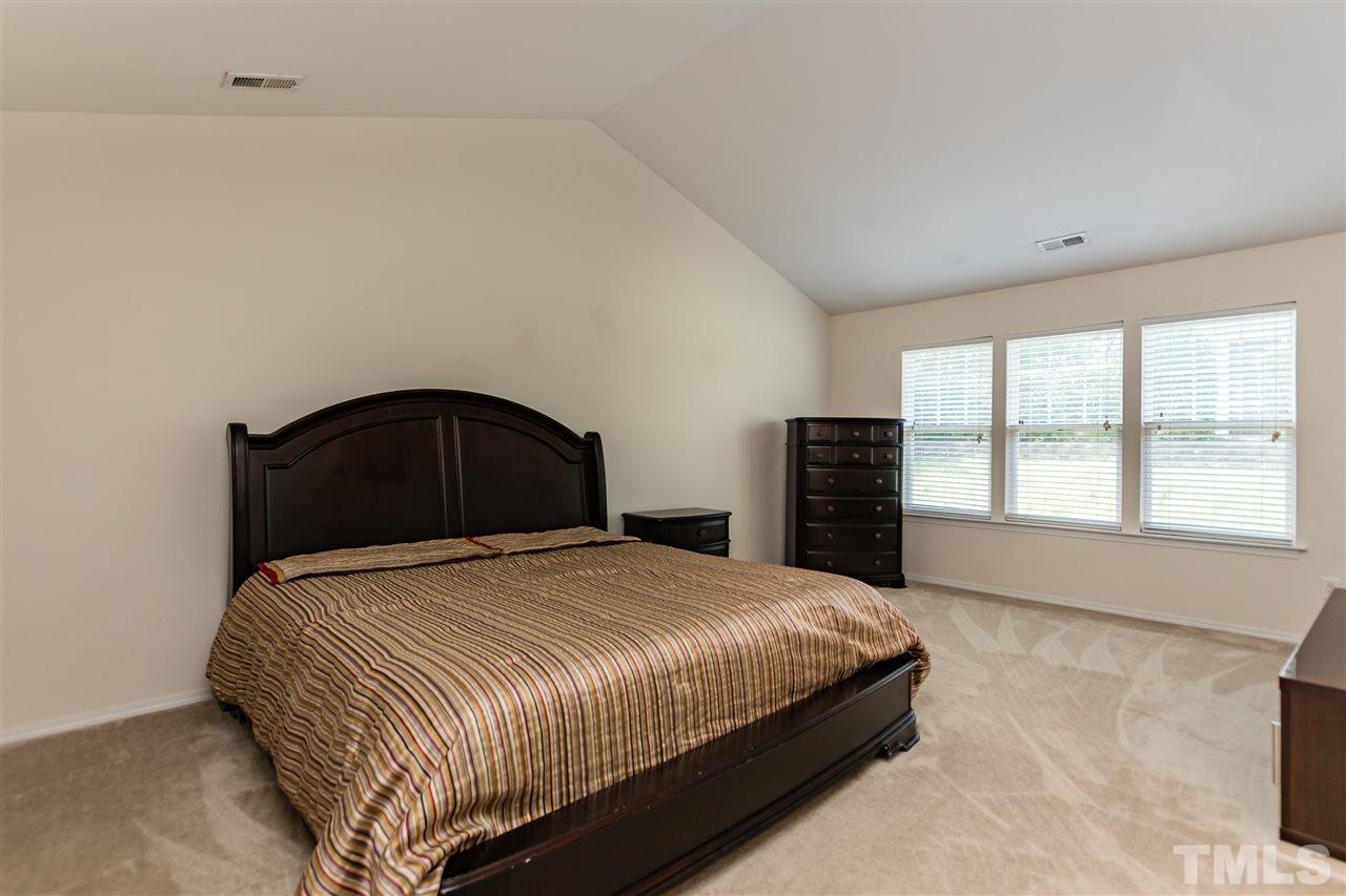 8313 Rubblestone Path Raleigh, NC 27613 - Photo 13 of 25 a bedroom with a bed and a window