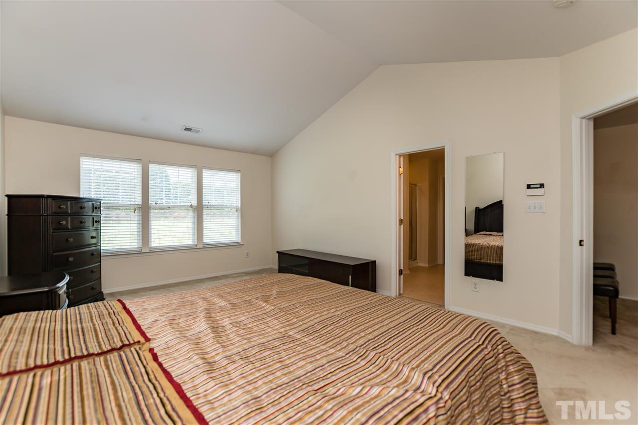 8313 Rubblestone Path Raleigh, NC 27613 - Photo 14 of 25 a bedroom with a bed and a dresser