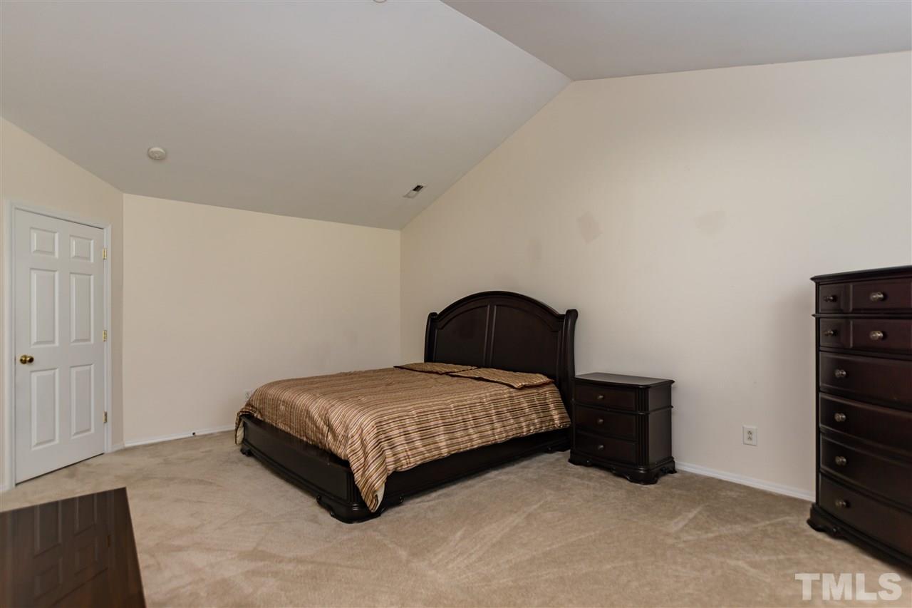 8313 Rubblestone Path Raleigh, NC 27613 - Photo 15 of 25 a bedroom with a bed and dresser