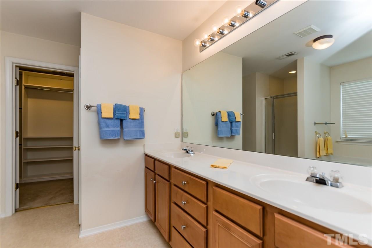 8313 Rubblestone Path Raleigh, NC 27613 - Photo 16 of 25 a bathroom with a double vanity sink and a mirror